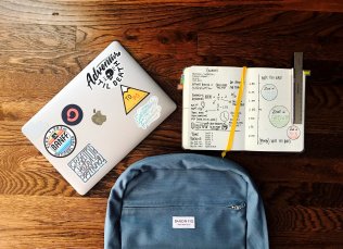 A book bag, a backpack and a notebook